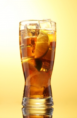 Iced tea with lemon and lime on yelow backgroundの写真素材