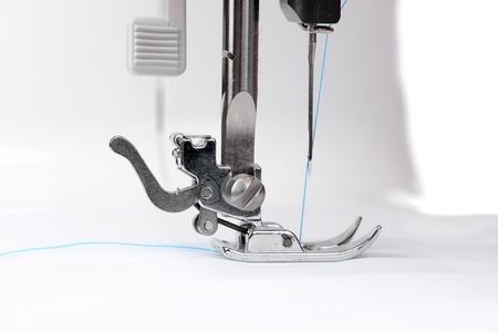 sewing machine and white fabric isolated on white