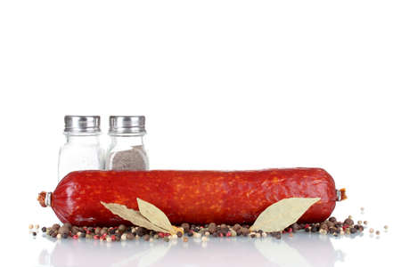 Tasty sausage and spices isolated on whiteの写真素材
