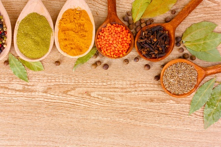 spices in the spoons on wooden backgroundの写真素材