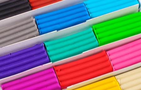 Children bright plasticine in a paper box closeupの写真素材