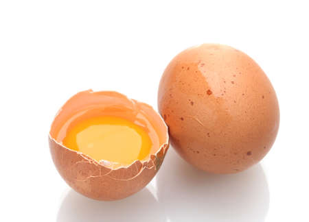 Brown eggs with yolk isolated on white
