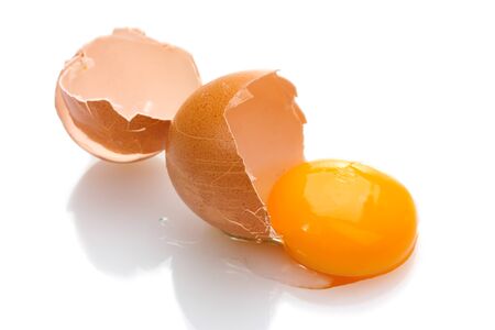 Brown egg with yolk isolated on white