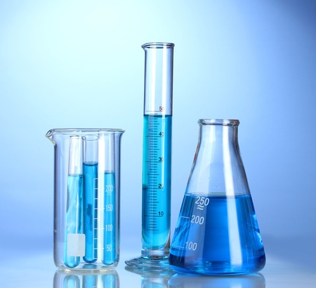 Laboratory glassware with blue liquid with reflection on blue backgroundの写真素材