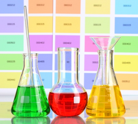 Three flasks with color liquid on color samples backgroundの写真素材