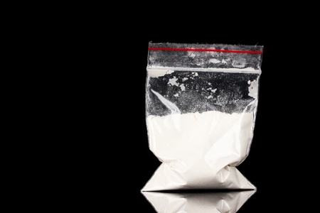 Cocaine in package on black backgroundの写真素材