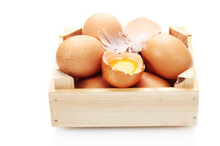 chicken eggs in wooden box isolated on white