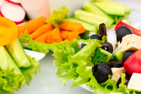 Greek salad on plate and sliced vegetables closeupの写真素材
