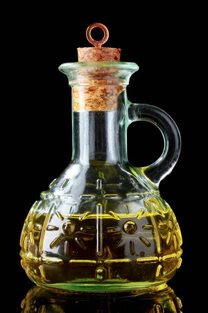 olive oil in jar on black backgroundの写真素材