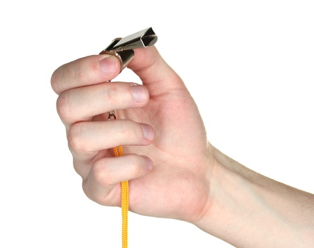 sport metal whistle in hand isolated on whiteの写真素材