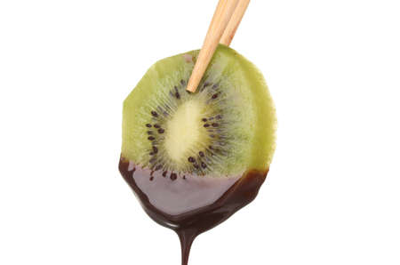 slice of ââripe kiwi with chocolate isolated on whiteの写真素材