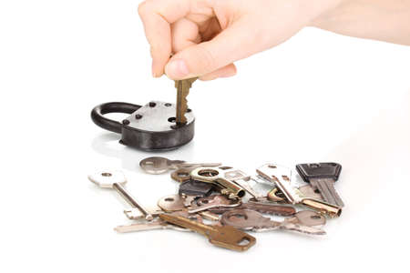 Selecting key to padlock isolated on white