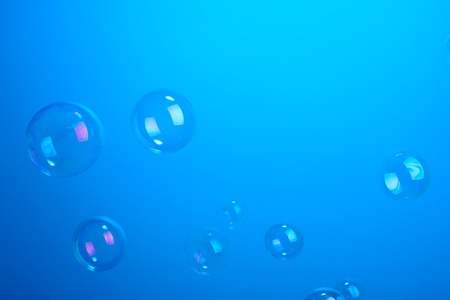 Soap bubbles on blue backgroundの写真素材