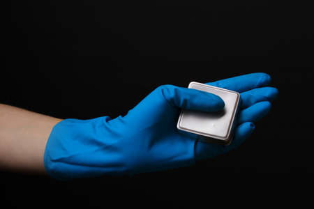 Uranium in hand isolated on blackの写真素材