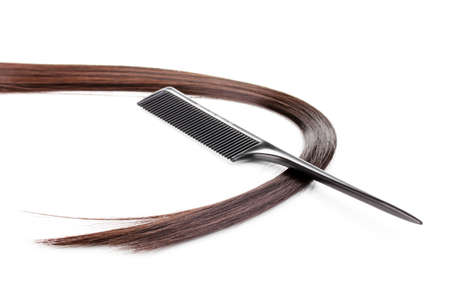 Shiny brown hair and comb isolated on white