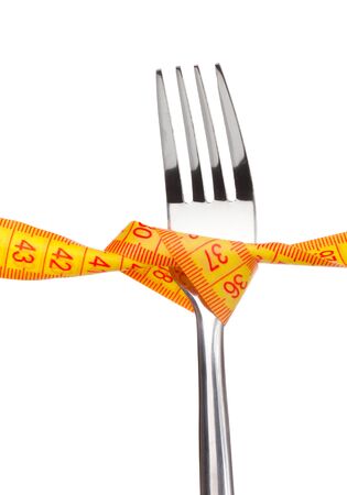 Fork and measuring tape isolated on whiteの写真素材