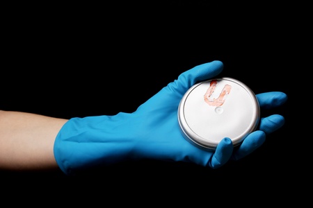 Uranium in hand isolated on blackの写真素材