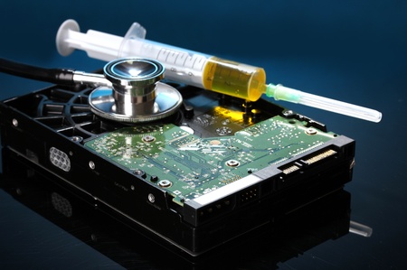 Stethoscope on hard disk drive on dark blue backgroundの写真素材