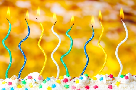 beautiful birthday candles  on yellow background