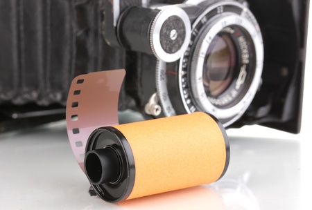 New photo film in cartridge and photocamera isolated on whiteの写真素材