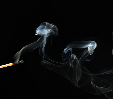 match with abstract smoke on black background