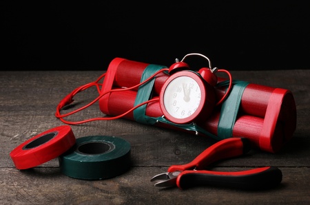Making timebomb on wooden table on black backgroundの写真素材