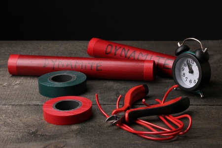 Making timebomb on wooden table on black backgroundの写真素材