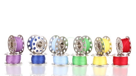 Metal spools of thread isolated on white