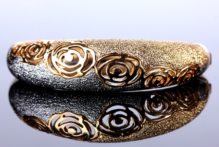 Beautiful golden bracelet on grey backgroundの写真素材