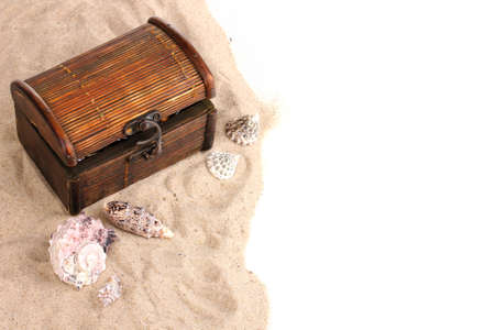 Chest and seashells on sandの写真素材