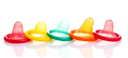 Colorful condoms isolated on whiteの写真素材