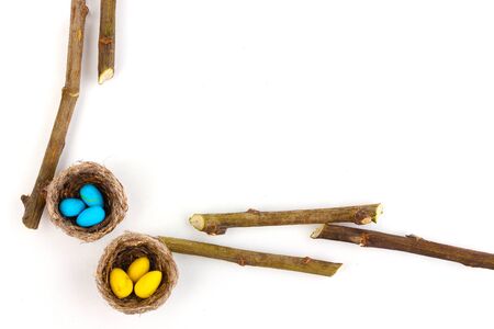 Colorful easter eggs in nests isolated on whiteの写真素材