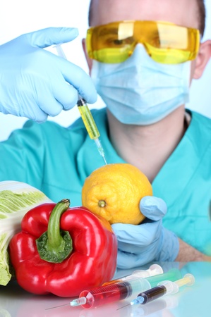 Scientist injecting GMO into the lemonの写真素材