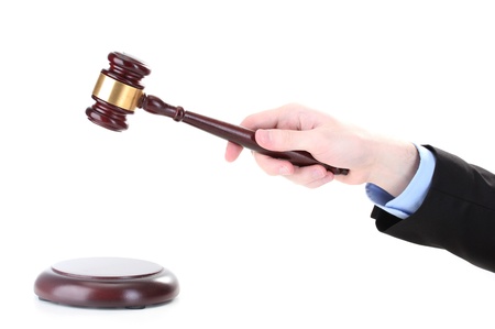 wooden gavel in hand isolated on whiteの写真素材