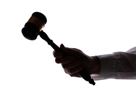 silhouette of woman's hand with gavel isolated on whiteの写真素材