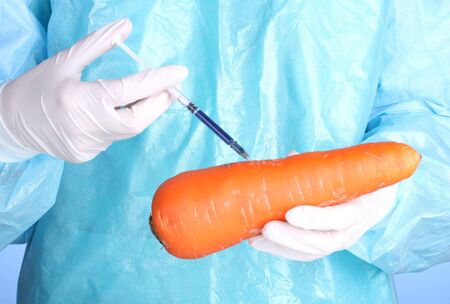 A scientist holds a genetically modified vegetableの写真素材