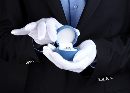 Man's hands holding ring in boxの写真素材