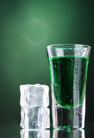 glass of absinthe and ice on green background
の写真素材
