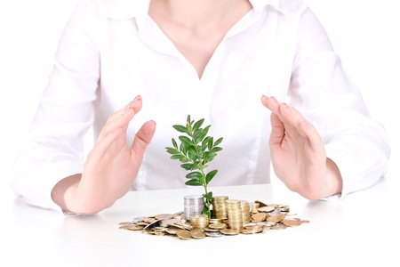 Woman hands with coins and plantの写真素材
