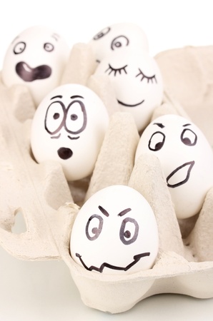White eggs with funny facesの写真素材