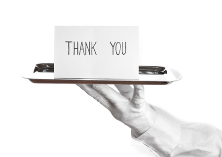 Hand in glove holding silver tray with card saying thank you isolated on white