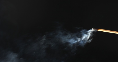 match with abstract smoke on black backgroundの写真素材