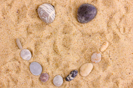 Smile-stones on sandの写真素材