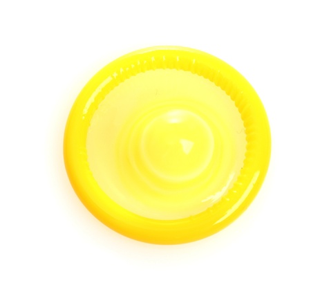 Yellow condom isolated on whiteの写真素材