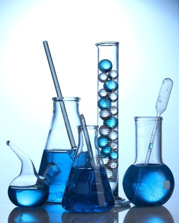 Test-tubes with blue liquid on blue backgroundの写真素材