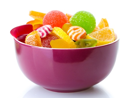 colorful jelly candies in purple bowl isolated on whiteの写真素材