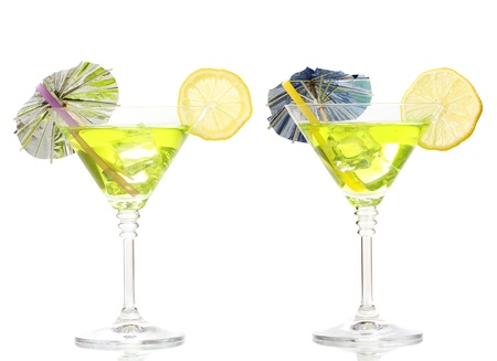 Yellow cocktail in martini glasses isolated on whiteの写真素材