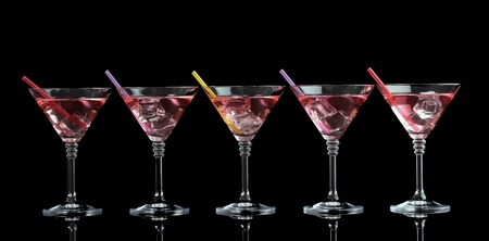 Red cocktail in martini glasses isolated on blackの写真素材