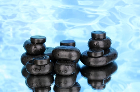 Spa stones with droplets on blue backgroundの写真素材