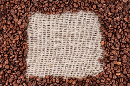 Frame of coffee beans on canvas backgroundの写真素材
